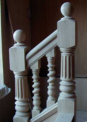 Fluted Oak newels with single twist balusters.
